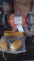 Central Machinery 6 inch bench grinder with two grinding wheels, orange body, tag attached.