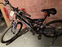 Side view of the blue Dyno adult mountain bike showing frame and tires.