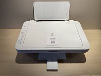 Canon MG2920 inkjet printer top view with paper tray open and control panel on the right side.