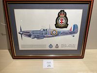 Framed artwork showing full image of a Spitfire II A aircraft, with squadron insignia and embroidered patch mounted on mat board.