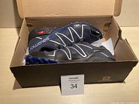 Pair of shoes in original Salomon box shown from above