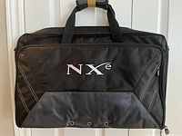 Front view of black NXe carry bag with embroidered NXe logo and ventilation grommets on front flap.