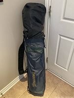 Front view of Spalding blue golf bag with padded shoulder strap and pockets.