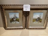 Two framed watercolour paintings positioned side by side, showing full frames and artwork.
