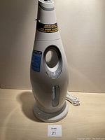 Front view of white ultrasonic humidifier showing water level indicator and control panel in vertical design