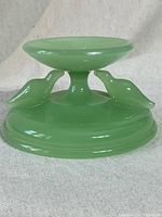 Front view showing two love birds on a jadeite pedestal candy bowl.