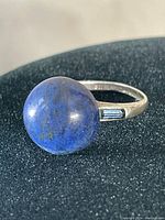 Front view of vintage sterling ring featuring round blue lapis lazuli stone approximately 0.5 inches diameter on a plain silver band.