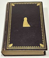 Front cover of the book with dark cover, gold-decorated border, and silhouette embossed in gold in the middle.