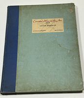 Full cover view showing blue cloth spine with light blue cover and printed label, exhibiting wear and age marks.