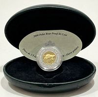 Front view of coin in clear capsule inside black clamshell case with round insert card showing coin details.