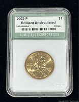 Front view of encapsulated 2002-P Sacagawea dollar coin with certification label from Numistrust Corporation
