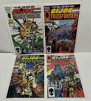 Front view of all four G.I.Joe and The Transformers comic issues, showing full covers and Marvel 25th Anniversary logo; all comics bagged and boarded.