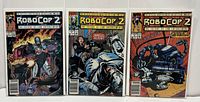 Three Marvel Robocop 2 comic issues #1-3 covered in protective sleeves, standing side by side showing front covers.