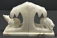 Front view of the pair of alabaster polar bear bookends showing bear figures and ice arch cutout.
