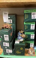 Green Boyd's Bears boxes piled with Christmas bear ornaments and figurines, showing original packaging and some items on display.
