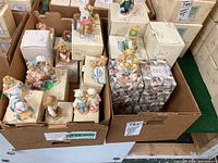 Boxes with Cherished Teddies figurines displayed on top, showing various teddy bears in different costumes and poses.