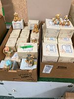 Two cardboard boxes filled with approximately 42 Cherished Teddies collectible teddy bear figurines and their original boxes.