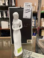 White porcelain Coalport figurine titled 'Thoughtful' and original black box in background, showing overall condition and details.