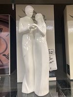 Front view of the white porcelain figurine "Forever Yours" by Royal Doulton, showing couple holding hands.