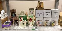 Photo of boxed and unboxed figurines on shelving, showing holiday themed Pooh Bear figures, Snowbabies, and alphabet letter figurines.