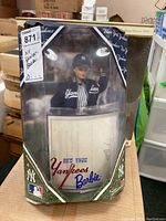 Front view of boxed New York Yankees Barbie doll in original packaging with visible logo and doll inside.