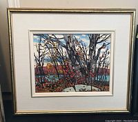 Straight-on view of framed landscape painting featuring birch trees and autumnal foliage by Thomas F. Chatfield in white mat and gold frame