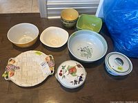 Overview of all seven serving bowls showing variety of styles and colors including yellow Pyrex, covered bowl, Staffordshire platter and ironstone bowls.