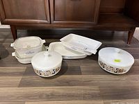 Overview of two Federal glass casseroles with lids, two Corelle rectangular baking dishes, and two Corning Ware rectangular dishes with blue floral motif.