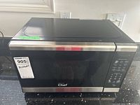 Front view of Master Chef microwave oven showing digital control panel, keypad, and door with viewing window.