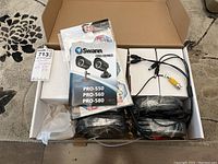 Opened box showing cables, manuals, and packaging