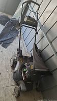 Briggs and Stratton Brute gas lawn mower showing overall body, wheels, and gas tank cap