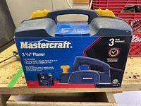 Closed box of Mastercraft 3 1/4" planer showing brand, model, and features.