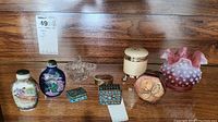 Seven small collectible items including miniature ceramic bottles, trinket boxes with turquoise stones, glass dish, and a decorative vase.