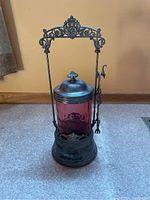 Front and side view of the vintage silver plate pickle jar with purple glass insert and lid.