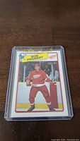 Front view of Bob Probert rookie hockey card with player in Detroit Red Wings uniform, encased in plastic protective holder.