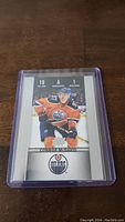Clear photo of the 2014-15 O-Pee-Chee Platinum Connor McDavid rookie hockey card in a protective case