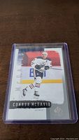 Photo of a Connor McDavid hockey trading card in protective plastic sleeve showing the player in Edmonton Oilers uniform.