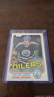 Front view of Kevin Lowe rookie hockey card in protective case showing player image, team name and logo.