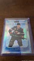 Clear front view of Kirill Kaprizov hockey card in protective case showing holographic blue finish and player in Minnesota Wild uniform.