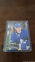 Mitch Marner rookie hockey card shown in protective sleeve on a wooden surface.