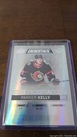 Front holographic view of Parker Kelly hockey card showing player name and stats