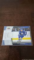 Phil Kessel trading card with embedded white Toronto Maple Leafs jersey swatch and player image in blue uniform.