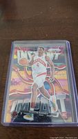 Front photo of Scottie Barnes rookie basketball card with colorful 'INSTANT IMPACT' background in a plastic protective case