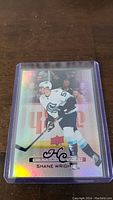 Photo showing Shane Wright rookie hockey card with holographic finish in clear plastic protective case