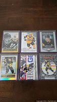 Six Sidney Crosby hockey cards arranged on a table, showing various card designs and poses