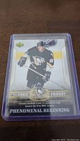 Close-up image of Sidney Crosby rookie hockey card in protective case showing front design and text details.
