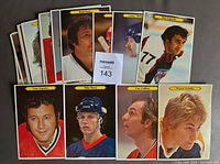 View of 23 OPC Super Hockey cards arranged showing various hockey players including Wayne Gretzky, Guy Lafleur, Mike Bossy, Tony Exposito, Phil Esposito, and others. Cards are 5x7 inches, large format, mostly good condition with some minor curls and corner dings.