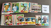 Photo showing multiple stacks of 1981 O.P.C. baseball cards spread out with visible front card faces like players and team shots.