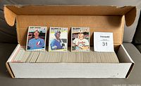 Long cardboard box with the full set of baseball cards inside, and three front baseball cards propped up: Ken Griffey Jr., Randy Johnson, Billy Ripken.