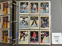 Binder page containing 9 hockey cards organized in 3x3 grid, showing players in various team jerseys from 1990-91 O.P.C. Premier set.